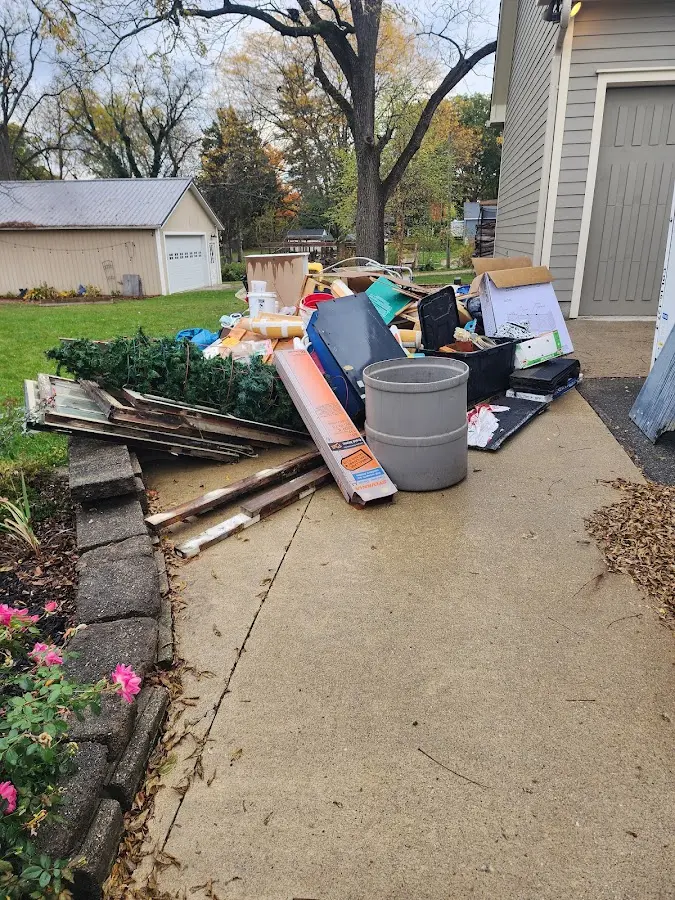 Dumpster being loaded with debris for Commercial Dumpster Rental in The Crossings